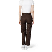Back view of dickies women tapered brown cotton blend trousers with matching belt and two rear pockets