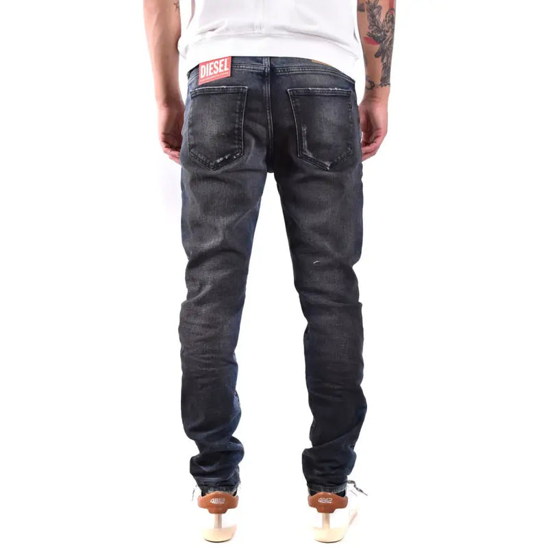 Back side of dark-wash diesel men jeans with blue worn out effect made from 100 cotton featuring distressed look
