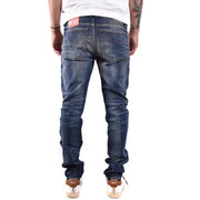 Dark blue denim jeans with faded wash and distressed details showing diesel label on the back waistband