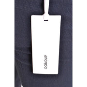 White rectangular dondup brand tag attached to dark navy cotton fabric of men’s spring summer blue trousers