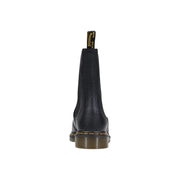 Dr Martens black leather ankle boots for women with textured finish and yellow stitching along the sole