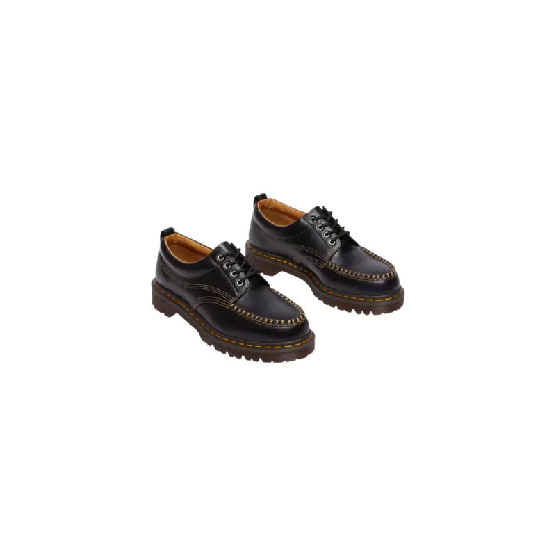 Black leather Dr Martens men Lowell moccasin shoes shown from the back side highlighting their sleek design