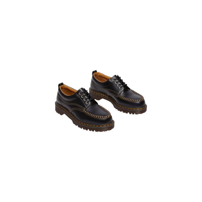 Black leather Dr Martens men Lowell moccasin shoes shown from the back side highlighting their sleek design