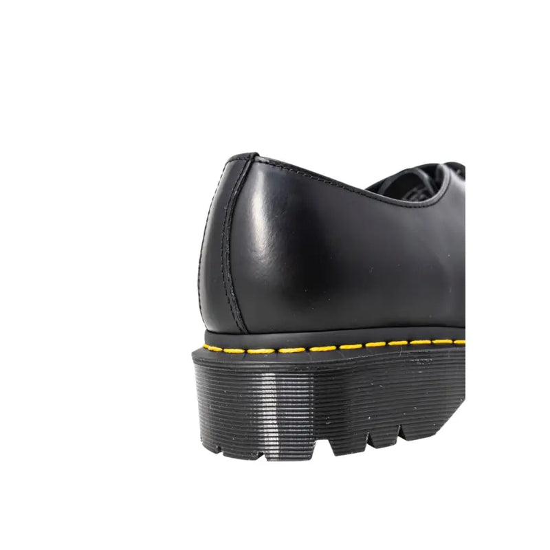 Dr martens men’s black leather lace-up shoes showing the back side with key stitching and heel loop details