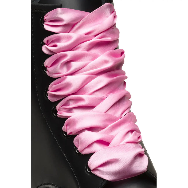 Dr Martens women fabric shoes pink featuring black eyelets threaded with pink satin laces on the front side