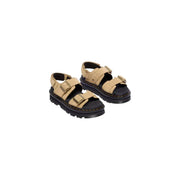 Dr martens women tan leather buckle sandals with black rubber soles and brass buckles shown from the back side