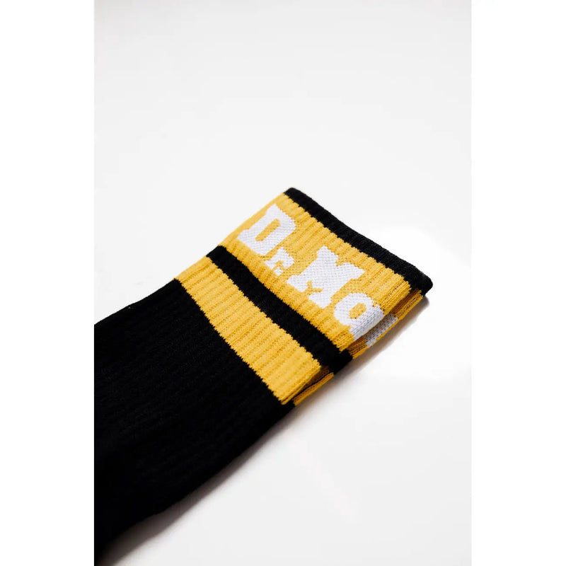 Black and yellow athletic sock with white lettering at the top made of cotton blend stretch for women by dr martens