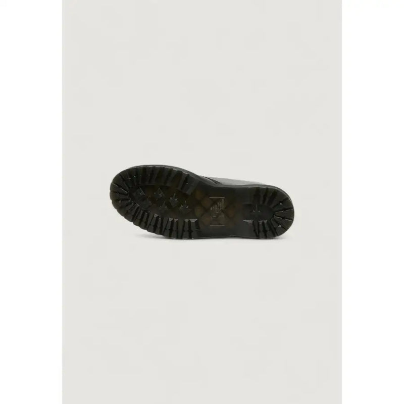 Black rubber sole with deep tread pattern and embossed dr martens logo on women’s black leather ankle boots for fall winter