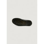 Black rubber sole with deep tread pattern and embossed dr martens logo on women’s black leather ankle boots for fall winter