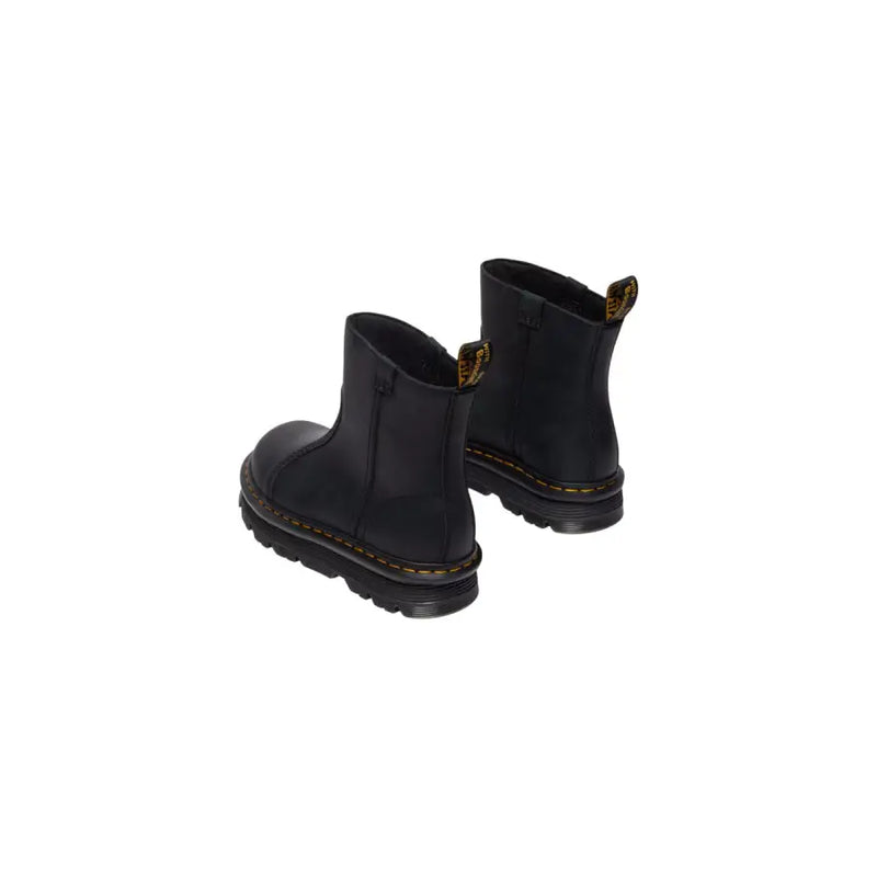 Dr Martens women’s black leather ankle boots showing the back side with durable stitching and heel loop