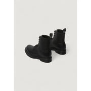 Dr Martens women’s black leather boots showing the back side with smooth leather and sturdy construction