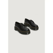 Chaussures Dr. Martens pour femmes, en cuir noir à lacets, vues de l'arrière, avec semelle extérieure et coutures emblématiques.