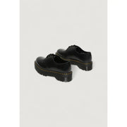 Chaussures Dr Martens pour femmes, en cuir noir à lacets, vues de l'arrière, mettant en valeur leur conception durable.