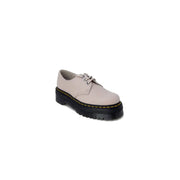 Beige leather dr martens women’s slip-on shoes showing the back side with durable leather material and slip-on design