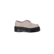Dr martens women’s grey leather slip-on shoe with beige leather platform, black rubber sole, and yellow stitching