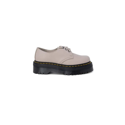 Dr martens women’s grey leather slip-on shoe with beige leather platform, black rubber sole, and yellow stitching