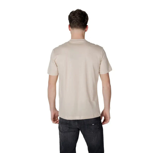 Men’s light beige short-sleeve cotton T-shirt paired with dark gray jeans for spring summer style