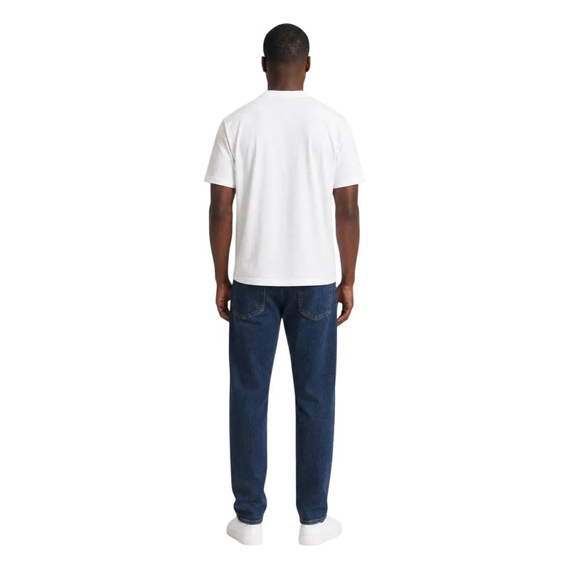 A man wearing an ea7 men white cotton t shirt classic fit with dark blue denim jeans