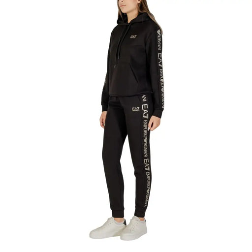 Black women’s tracksuit with white side stripe branding from EA7 women’s printed black hooded jumpsuit
