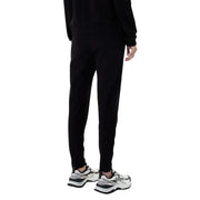 Ea7 women’s black hooded jumpsuit with pockets paired with black tapered jogger pants featuring a sleek modern fit