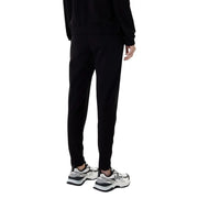 Ea7 women’s black hooded jumpsuit with pockets paired with black tapered jogger pants featuring a sleek modern fit