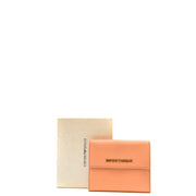 A peach colored leather wallet with gold-tone emporio armani logo plaque designed for women with pockets