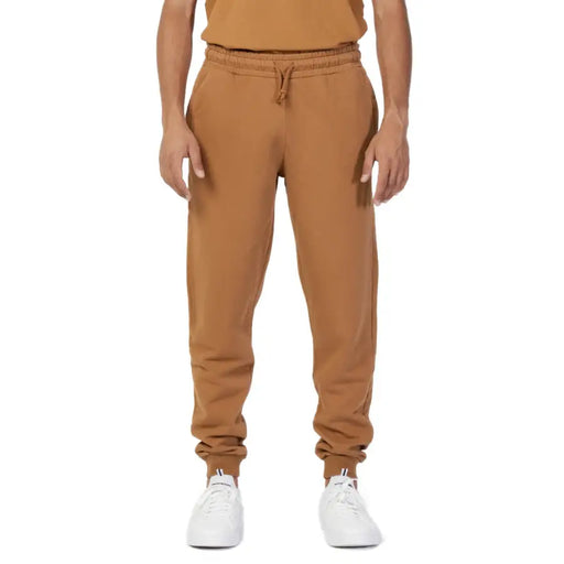 Men’s plain brown cotton sweatpants with drawstring and white athletic shoes for casual wear