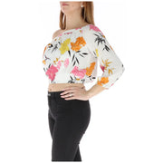 Floral off the shoulder crop top in white with vibrant pink orange yellow floral patterns and black leaf accents