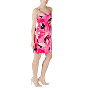 A vibrant fuchsia floral print sleeveless dress with black and cream accents and thin spaghetti straps