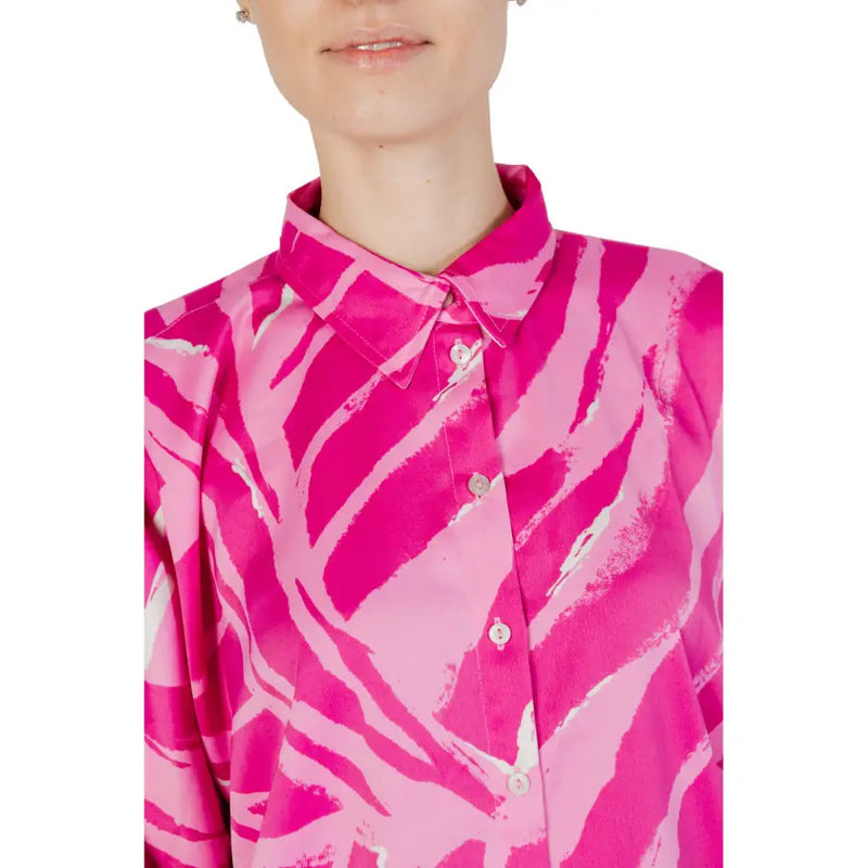 A vibrant fuchsia women’s long button-down shirt with pink zebra print, crisp collar, and matching buttons for spring and summer