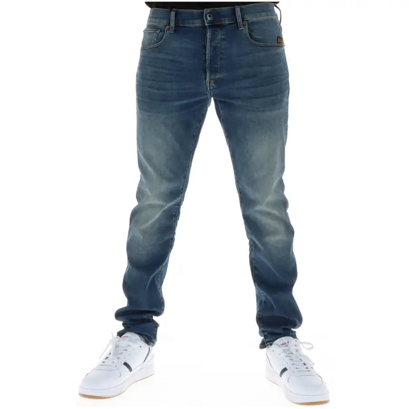 Back side of g-star men jeans 51001 featuring dark-wash slim fit denim with button fly cotton stretch and brown brand patch