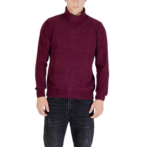 Burgundy turtleneck sweater with a subtle pattern and ribbed cuffs, collar, and hem.