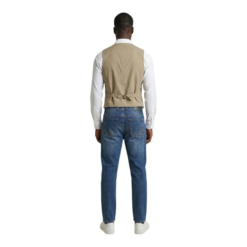 Beige cotton stretch waistcoat with belt detail by Gianni Lupo worn over white shirt and paired with blue jeans