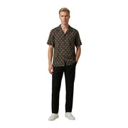 A man wearing a Gianni Lupo men shirt in black with an intricate gold geometric pattern and short sleeves
