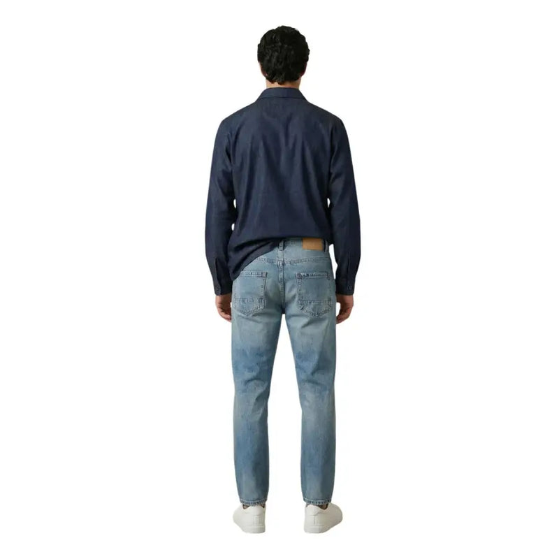 A pair of light-wash denim jeans with classic five-pocket design and subtle fading for men by gianni lupo
