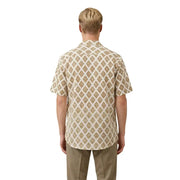 A man wearing a short-sleeved cream-colored Gianni Lupo men shirt with an intricate brown geometric pattern