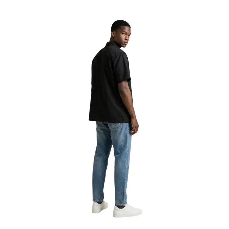 Gianni Lupo men shirt black short-sleeved button-up paired with blue jeans and white sneakers for casual wear