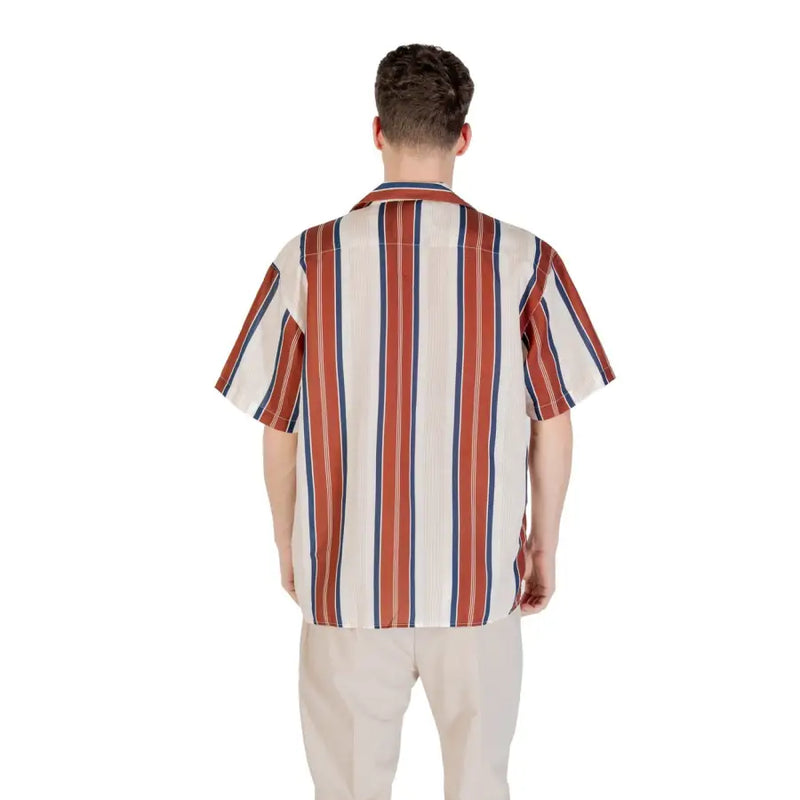 A man wearing a gianni lupo mens beige striped linen shirt with cream rust red and navy blue vertical stripes