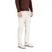 White slim fit chinos pants with elastic waistband and button fly, made of cotton blend material.
