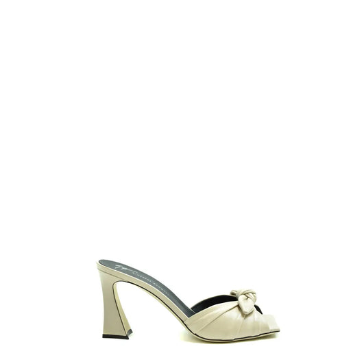Giuseppe Zanotti white leather block heel slippers featuring a cream leather mule design with knotted bow detail