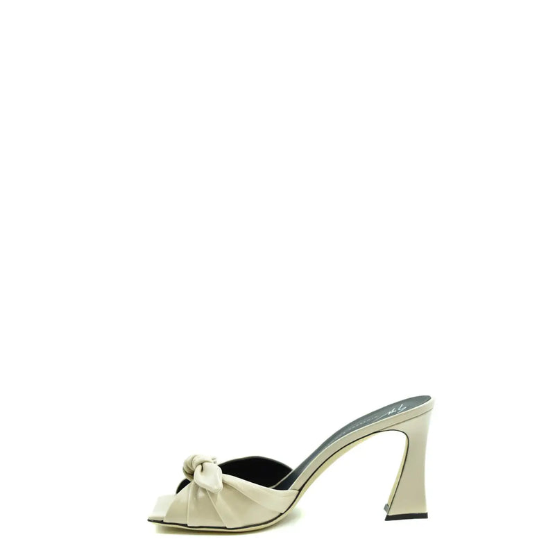 Cream-colored satin Giuseppe Zanotti block heel mule sandals with black insole and decorative bow at the toe