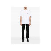 White oversized t-shirt with small red star logo paired with Givenchy men black slim fit stretch denim jeans