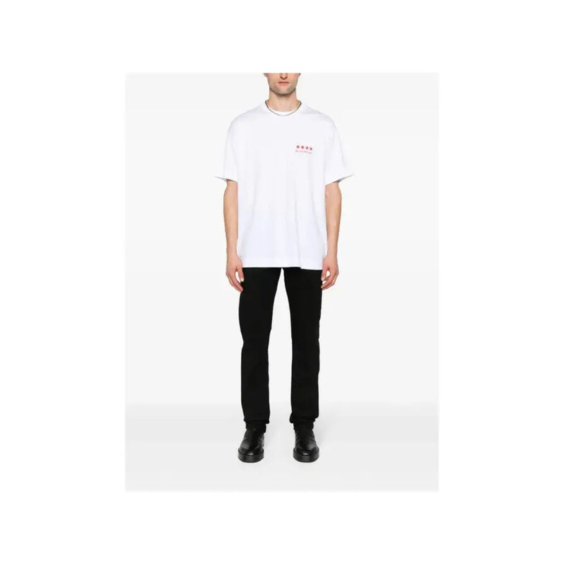 White oversized t-shirt with small red star logo paired with Givenchy men black slim fit stretch denim jeans