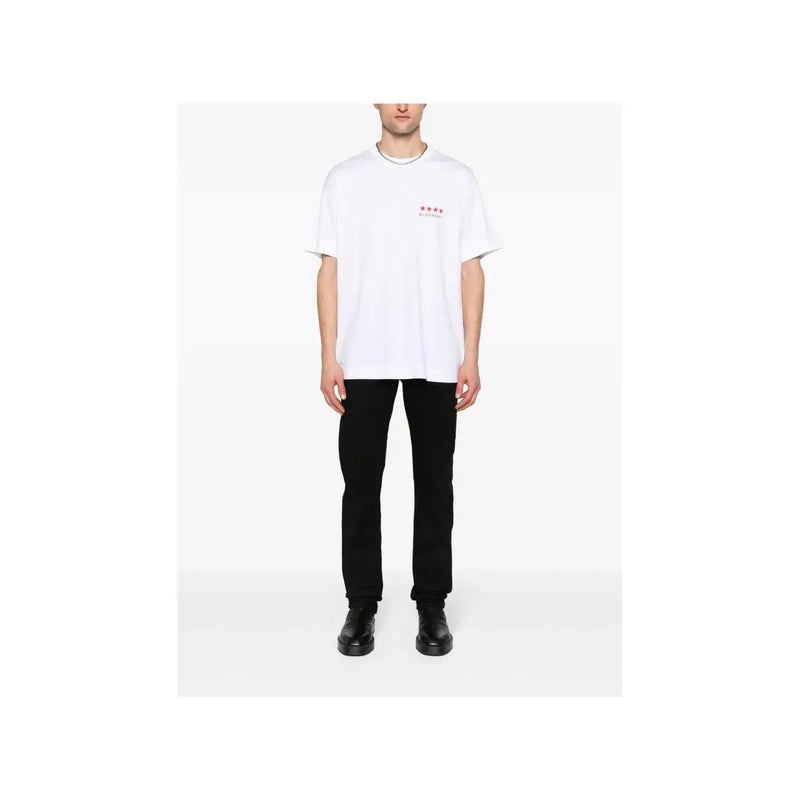 White oversized t-shirt with small red star logo paired with Givenchy men black slim fit stretch denim jeans