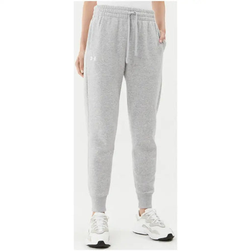Gray heathered drawstring sweatpants with side pockets and under armour logo on the left thigh