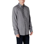 Gray patterned men’s long sleeved shirt with subtle dark geometric shapes on lightweight fabric for formal wear