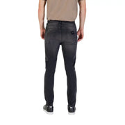 Gray slim-fit jeans paired with black sneakers and a tan T shirt for a stylish look