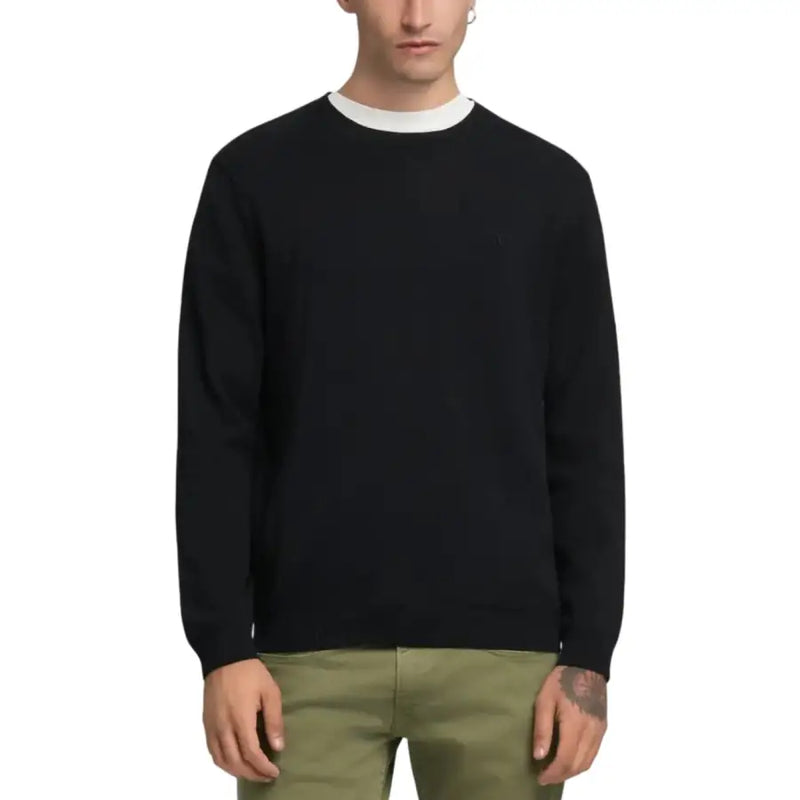Black crew neck sweater with white collar and cuffs, likely made of cotton or a similar soft fabric.