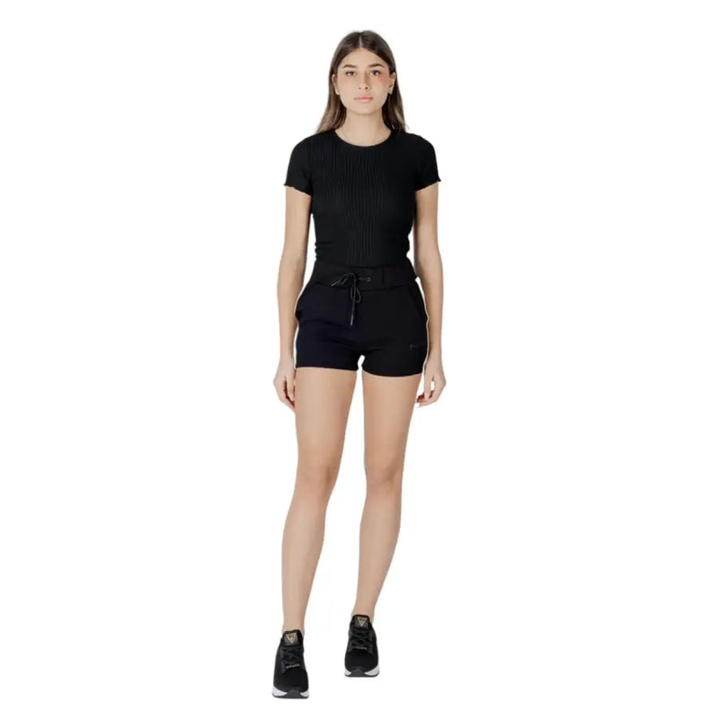 Black ribbed short sleeve top with fitted silhouette and elastic waistband in cotton polyester blend by Guess Active Women