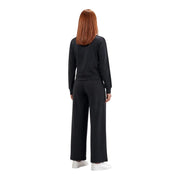 Black guess active women lyra straight pant trousers paired with relaxed fit long-sleeved sweatshirt with ribbed cuffs